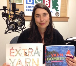 Carmine Rau, Youth Services Librarian at Bainbridge Public Library, holds up two books that prove that she did not make up the idea of "yarn bombing"
