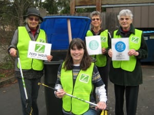 Diane Landry (kneeling) leads a Zero Waste team at an event -- (left to right) Gerlind Jenkner, Rosemary Courtright and Marci Burkel.