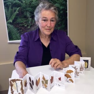 Susan Callan with her "Leaves" collection in the form of an accordian-style artist's book 